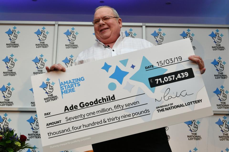 Ade Goodchild with his £71m EuroMillions cheque (PA)