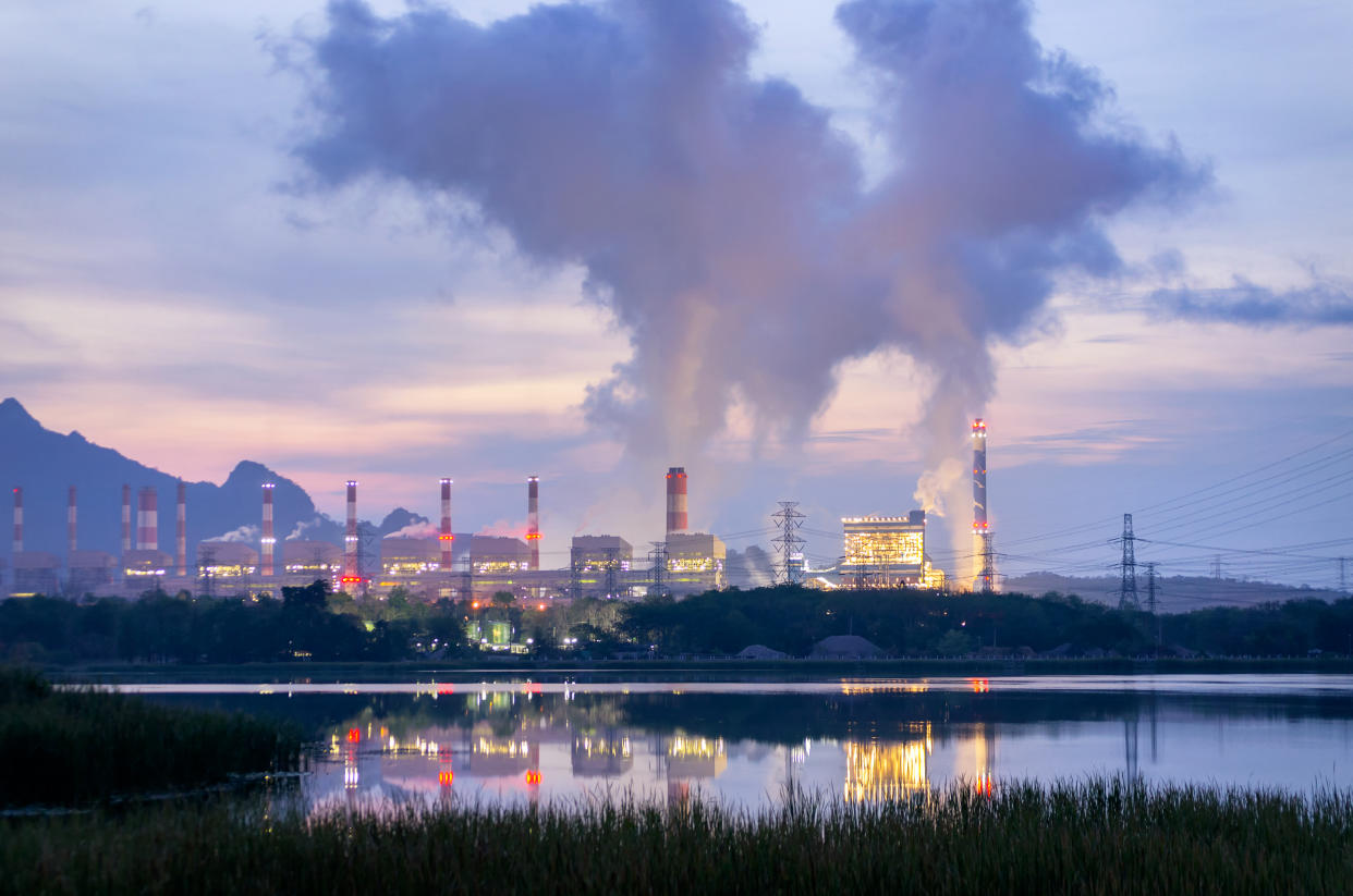 Steam fumes above the coal power plant in large area The machine is working to generate electricity the beautiful morning with fog and clouds, air pollution.