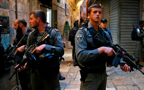 Israeli security forces stand guard at the site of a stabbing - Credit: AFP