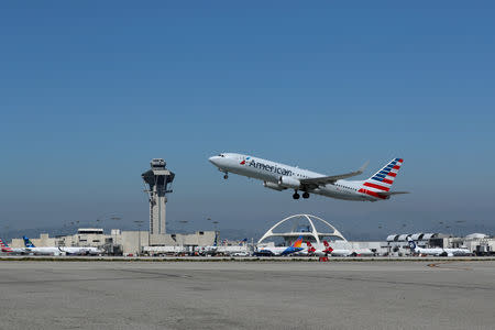 FILE PHOTO: An American Airlines Boeing 737-800 plane takes off from Los Angeles International airport (LAX) in Los Angeles, California, U.S. March 28, 2018. REUTERS/Mike Blake