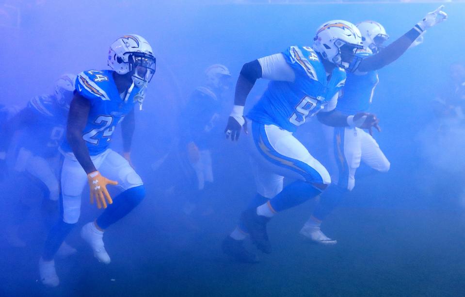 <p>Los Angeles Chargers players run out for the start of the NFL match with Tennessee Titans at Wembley. The national stadium was the subject of a bid by Shahid Khan in 2018, which the billionaire owner of Fulham and Jacksonville Jaguars later withdrew (Simon Cooper/PA) </p>