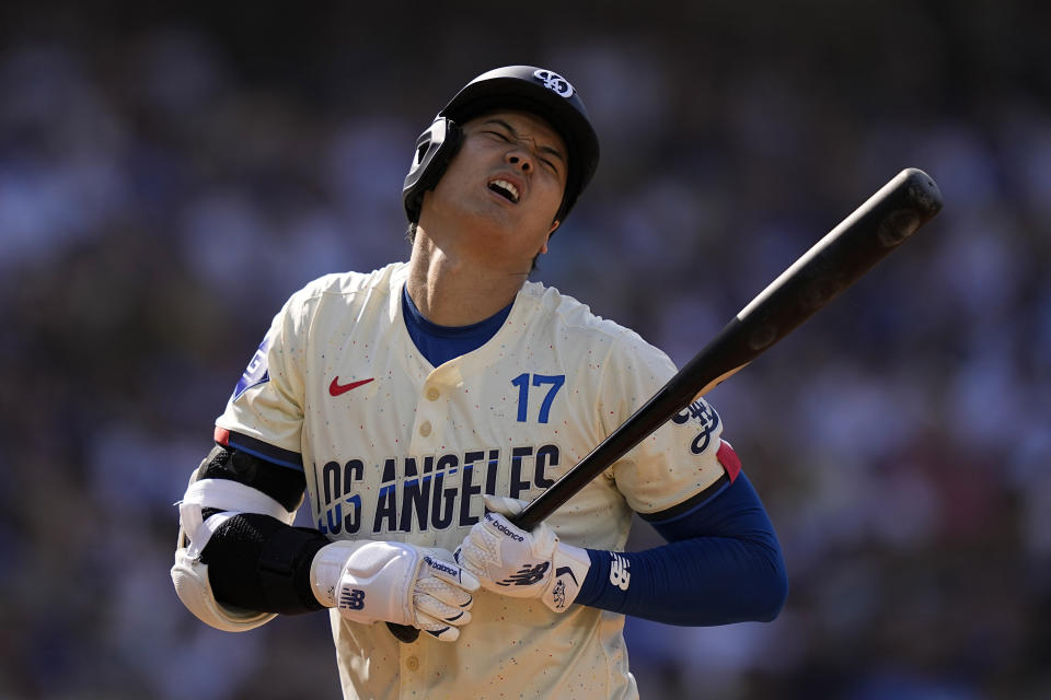 Los Angeles Dodgers' Shohei Ohtani reacts after being hit by a pitch during the second inning of a baseball game against the Milwaukee Brewers Saturday, July 6, 2024, in Los Angeles. (AP Photo/Mark J. Terrill)