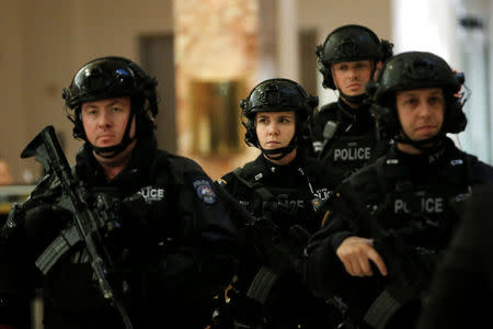 Heavily armed New York City Police (NYPD) officers patrol through the lobby at Trump Tower where U.S. President-elect Donald Trump lives in New York, U.S., November 29, 2016. REUTERS/Mike Segar