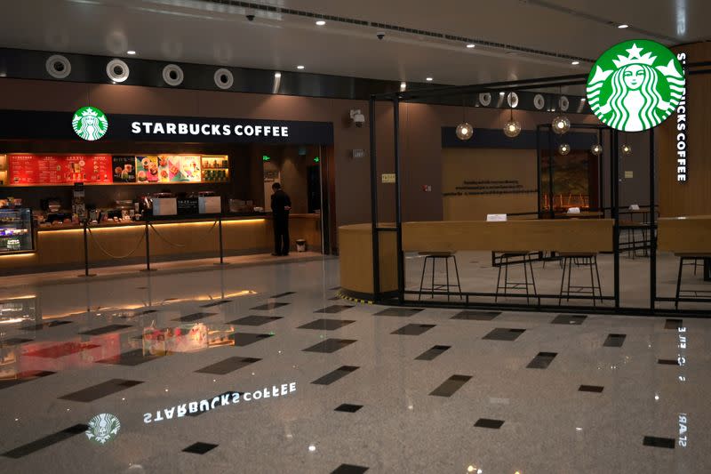 Staff member is seen at Starbucks at the Beijing Daxing International Airport, as the country is hit by an outbreak of the novel coronavirus, in Beijing