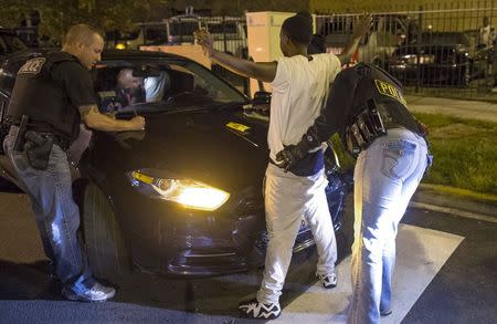 Cook County Sheriff police officers search a vehicle and a woman at street stop in the Austin neighborhood in Chicago, Illinois, United States, September 9, 2015. REUTERS/Jim Young