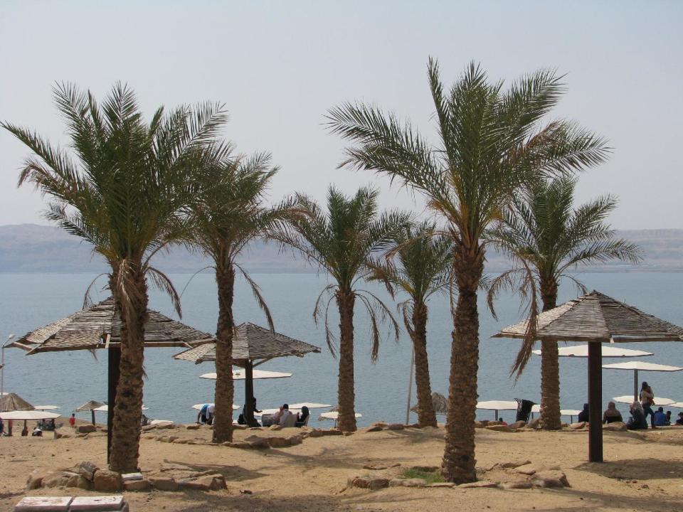 This April 22, 2016, photo shows Amman Beach on Jordan's shore of the Dead Sea, which is actually a spectacular lake 1,400 feet (400 meters) below sea level. This Middle Eastern country delivers a blockbuster list of iconic ancient monuments, otherworldly landscapes and warmhearted hospitality, with Petra as its tourism jewel. (Giovanna Dell'Orto via AP)