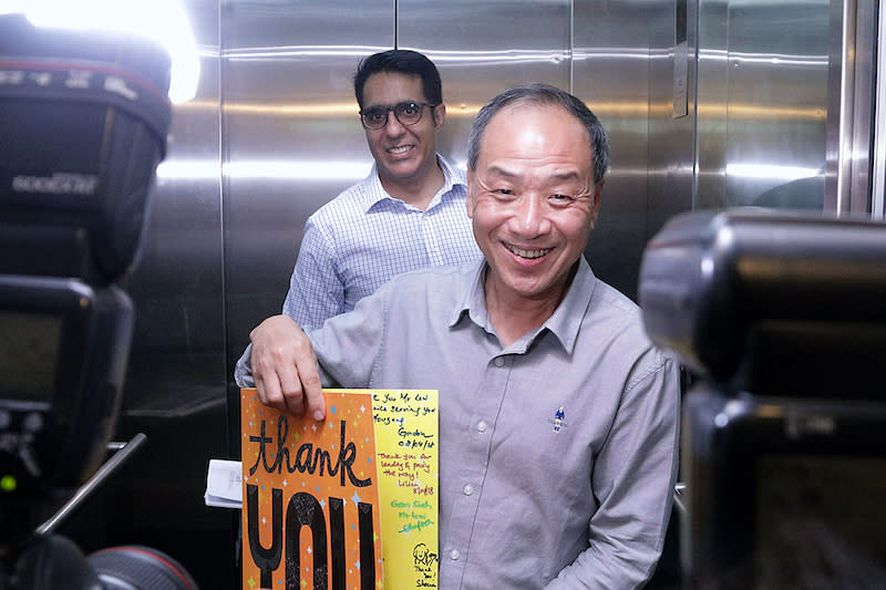 Outgoing Workers' Party chief Low Thia Khiang holds up a thank you card from supporters, as his successor Pritam Singh looks on at the party's HQ in Geylang Road, on 8 April 2018.   (PHOTO: Dhany Osman/Yahoo News Singapore) 