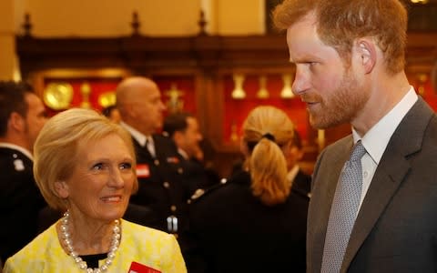 Prince Harry and Mary Berry at the London Fire Brigade carol service - Credit: Peter Nicholls /Getty