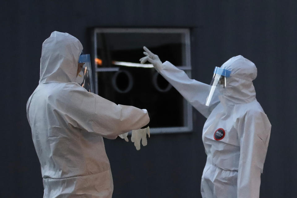 Medical workers wearing protective gears prepare to take samples during a COVID-19 testing at coronavirus testing site in Seoul, South Korea, Thursday, Dec. 17, 2020. (AP Photo/Lee Jin-man)