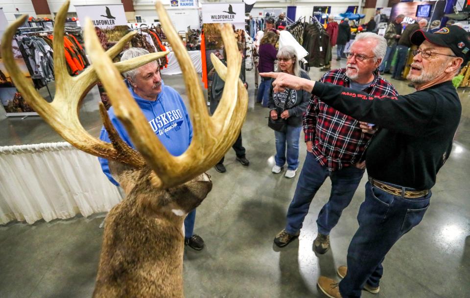 Marlon Laiblaw, president of Wisconsin Buck and Bear Club, right, discusses how bucks antlers are measured to Joe Schilz, left, during the Milwaukee Journal Sentinel Sports Show in 2022, inside of the Wisconsin Exposition Center at State Fair Park in West Allis.