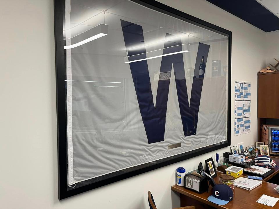 The 'W' flag that that the Chicago Cubs flew over Wrigley Field after winning Game 7 of the 2016 World Series adorns the wall in Cubs' manager David Ross' office.