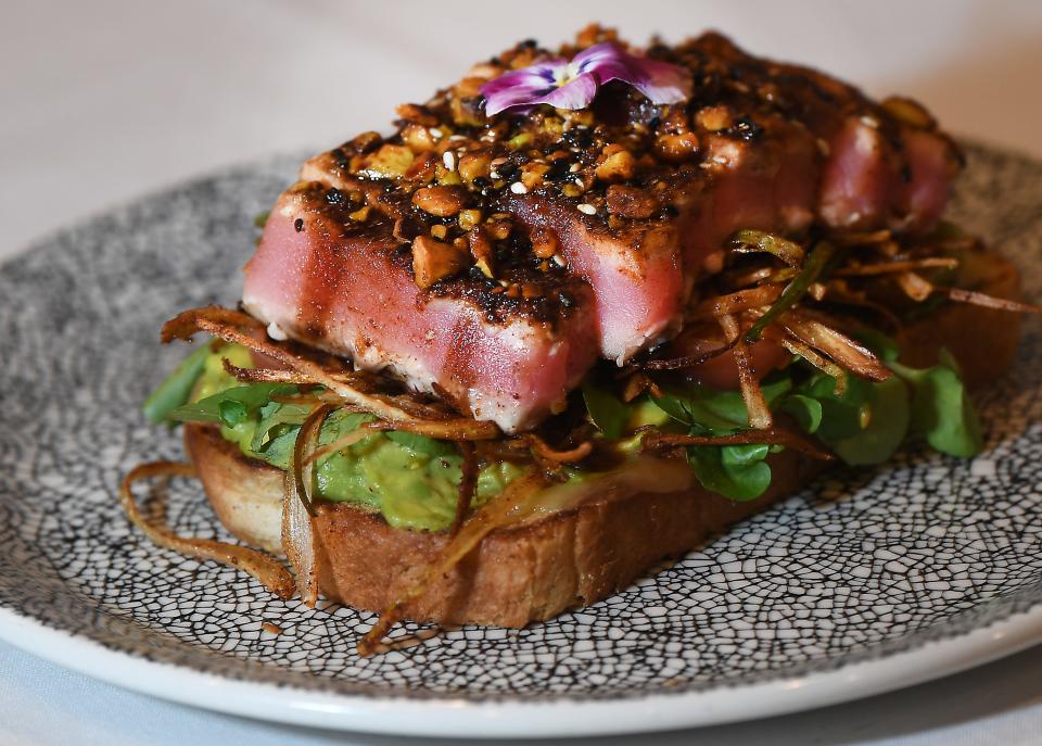 This is one of the dishes at Maestro's Bistro & Dinner Club in downtown Greenville. Tuna Toast - an open face sandwich of blackened crusted pistachio sesame seeds, tuna, on rye bread, with crush avocado lime, heirloom grape tomatoes, crispy leeks, drizzle with soy glaze