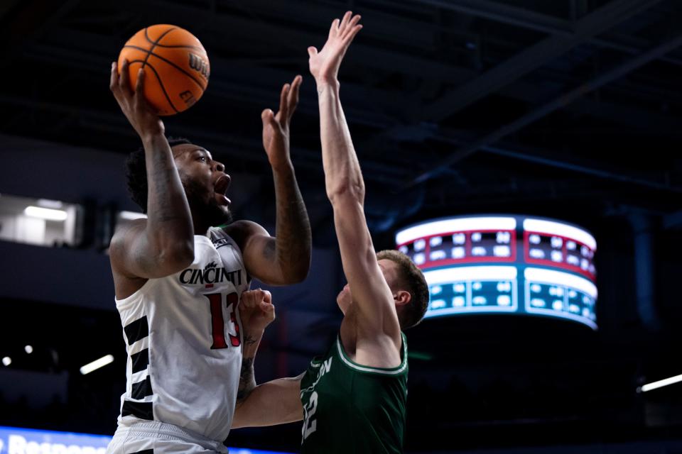 Cincinnati Bearcats forward Jamille Reynolds (13) hits a basket over Stetson Hatters forward Treyton Thompson (42) in the first half of the basketball game between Cincinnati Bearcats and Stetson Hatters at Fifth Third Arena in Cincinnati on Friday, Dec. 22, 2023.