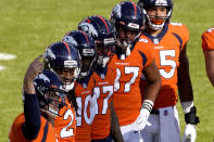 Denver Broncos quarterback Drew Lock, left, motions to his sideline as his teammates look on during the first half of an NFL football game again the Los Angeles Chargers, Sunday, Nov. 1, 2020, in Denver. (AP Photo/Jack Dempsey)