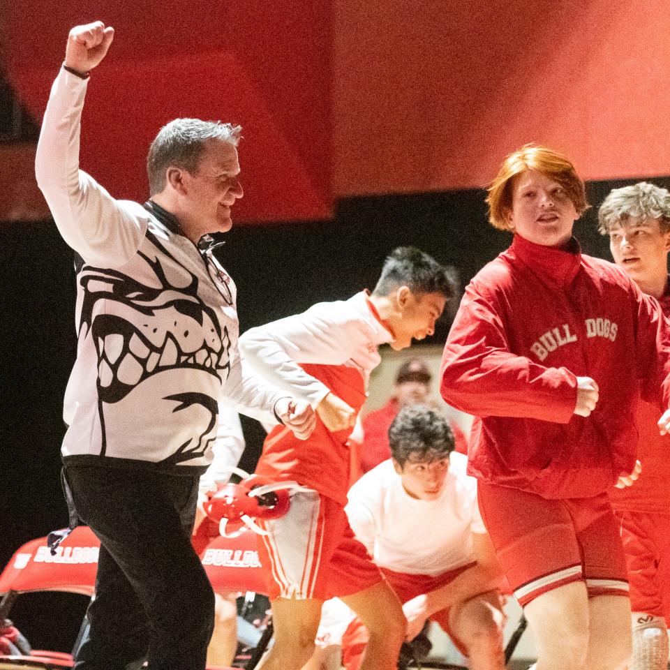 The Oak Hills wrestling team celebrates during its match against Serrano on Thursday, Jan. 20, 2022. Oak Hills won the meet to clinch another Mojave River League title.