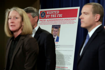 Acting AAG for National Security Mary McCord speaks in front of a poster of a suspected Russian hacker during FBI National Security Division and the U.S. Attorney's Office for the Northern District of California joint news conference at the Justice Department in Washington, U.S., March 15, 2017. REUTERS/Yuri Gripas