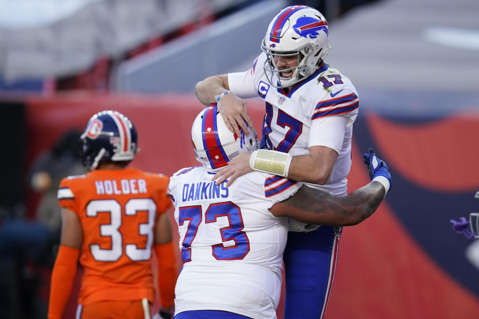 Buffalo Bills quarterback Josh Allen, above, celebrates with teammate offensive tackle Dion Dawkins after scoring a touchdown. (AP Photo/David Zalubowski)