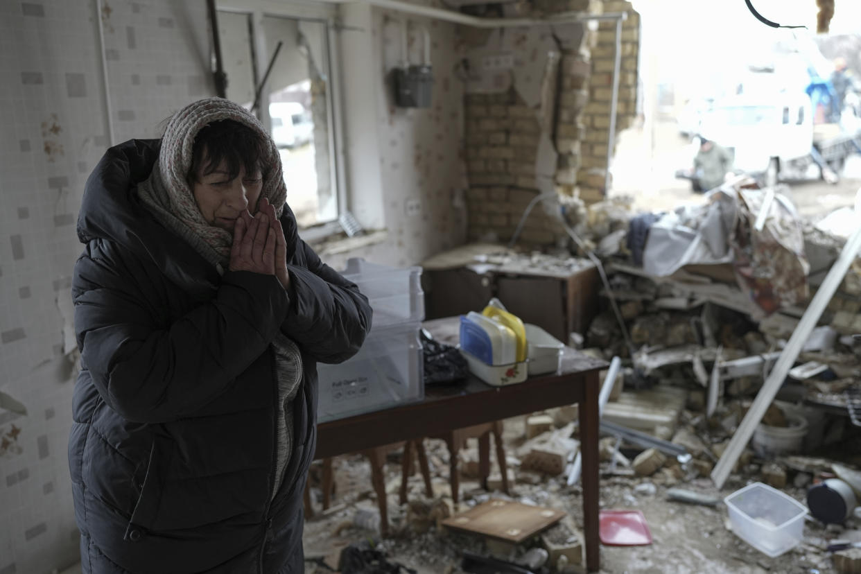 Halina Panasian weeps inside her destroyed house after a Russian rocket attack. 