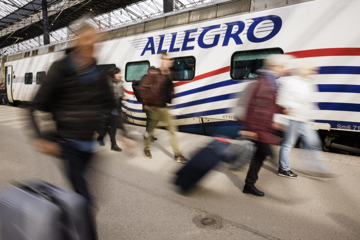 Passengers disembark from the second last train from St. Petersburg, Russia, at the railway station in Helsinki, on Sunday March 27, 2022. One of the last remaining passenger train links from Russia into the European Union has been suspended following the departure of the last two Allegro high-speed trains from St. Petersburg to Helsinki.(Seppo Samuli/Lehtikuva via AP)