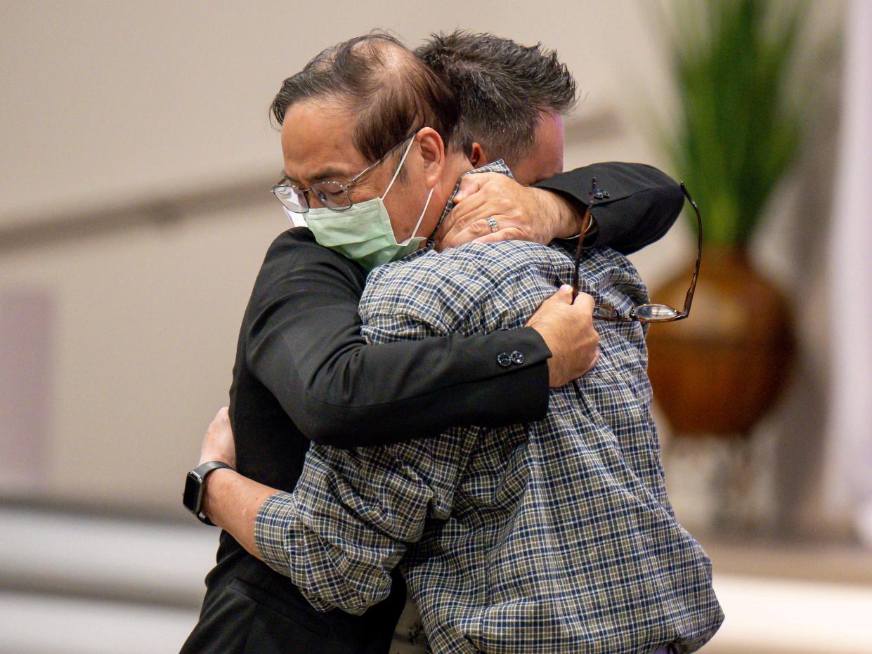 Rev. Jason Aguilar, left, embraces an emotional Pastor Billy Chang, who was at the the Taiwanese Presbyterian service in Laguna Woods when the shooting broke out, during a prayer vigil at Christ Our Redeemer (COR) A.M.E. Church in Irvine on Monday, May 16, 2022.