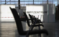 In this Thursday, Nov. 26, 2020 photo chairs are placed in an exhibition hall in Husum, Germany. Corona vaccination centres in all 15 districts and independent towns in the German state of Schleswig-Holstein should be ready to start by mid-December. Germany prepares for the vaccination of the German population during the upcoming month. Word reads 'Vaccination Center'.(Christian Charisius/dpa via AP)