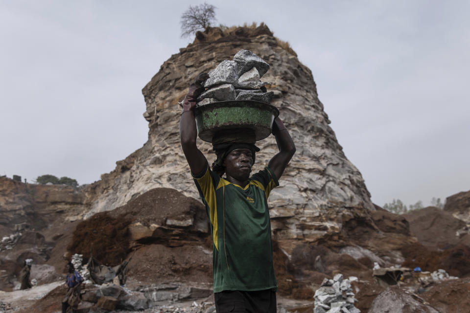 Men work in a Pissy granite mine in Ouagadougou, Burkina Faso, Monday April 25, 2022. he influx of people displaced by the country's rapidly rising Islamic violence is causing competition among the approximately 3,000 people working at the granite mine. At least 500 displaced people started working at the mine last year making it harder for the original miners to earn a living, said Abiba Tiemtore, head of the site. (AP Photo/Sophie Garcia)