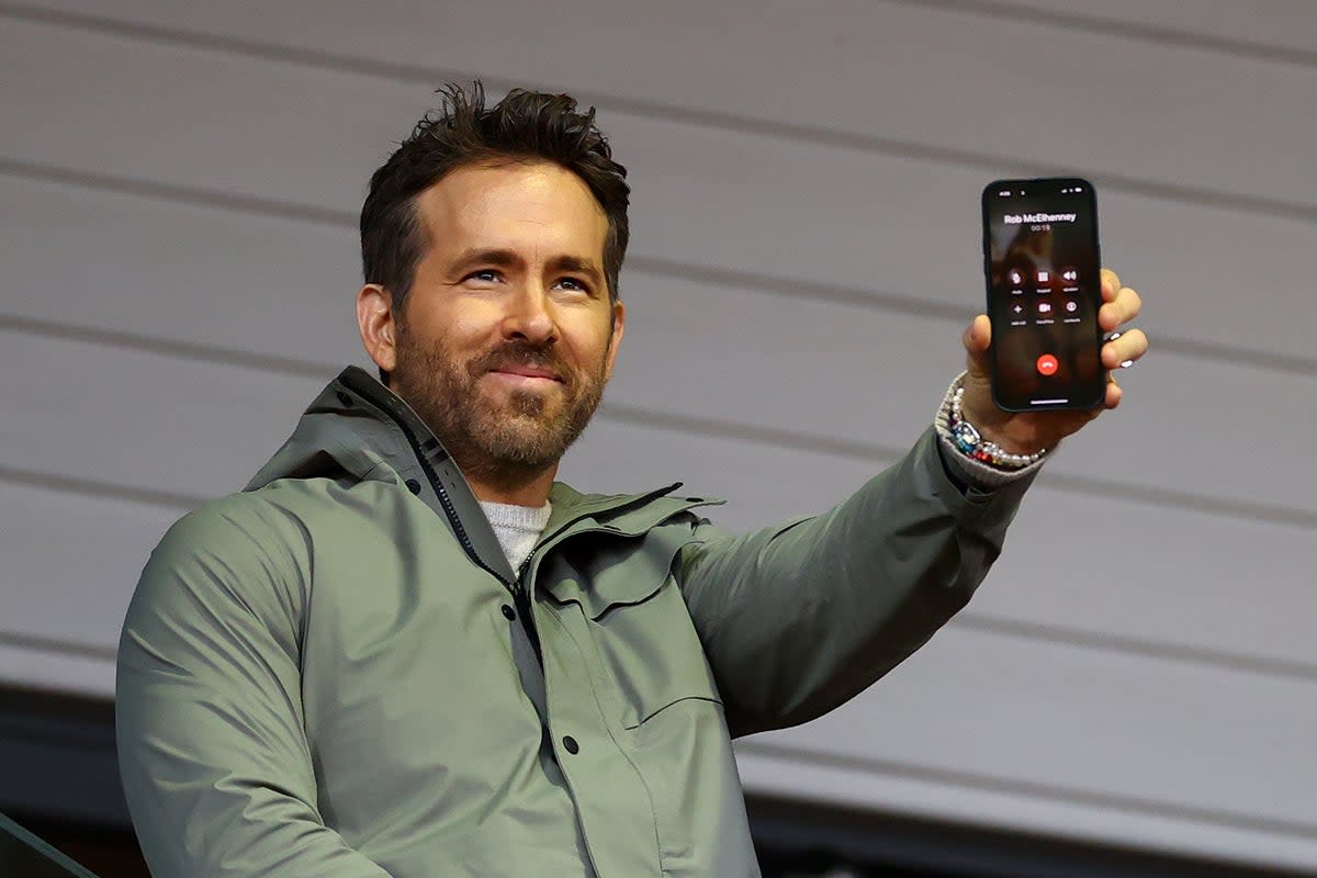 Ryan Reynolds speaks to Rob McElhenney, fellow co-owner of Wrexham, on the phone during the match  (Getty Images)