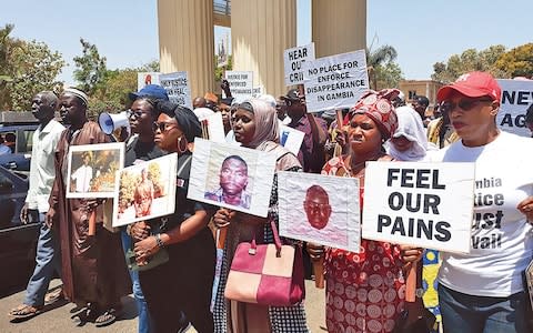 Relatives of Jammeh's victims demonstrate in Banjul - Credit: Getty Images