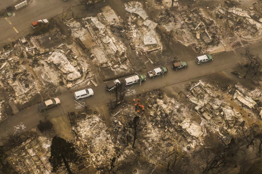 ASHLAND, OR - SEPTEMBER 11: In this aerial view from a drone, search and rescue personnel from the Jackson County Sheriff's Office look for the possible remains of a missing elderly resident in a mobile home park on September 11, 2020 in Ashland, Oregon. Hundreds of homes in Ashland and nearby towns have been lost due to wildfire. (Photo by David Ryder/Getty Images)