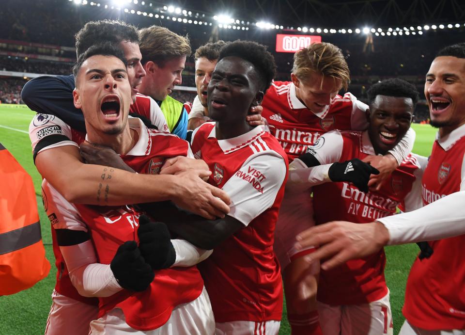 Gabriel Martinelli celebrates with his teammates after scoring against West Ham in their Premier League match. 