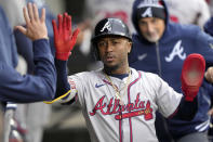 Atlanta Braves' Ozzie Albies celebrates in the dugout after scoring on a Austin Riley's single during the sixth inning of a baseball game against the Chicago White Sox Monday, April 1, 2024, in Chicago. (AP Photo/Charles Rex Arbogast)