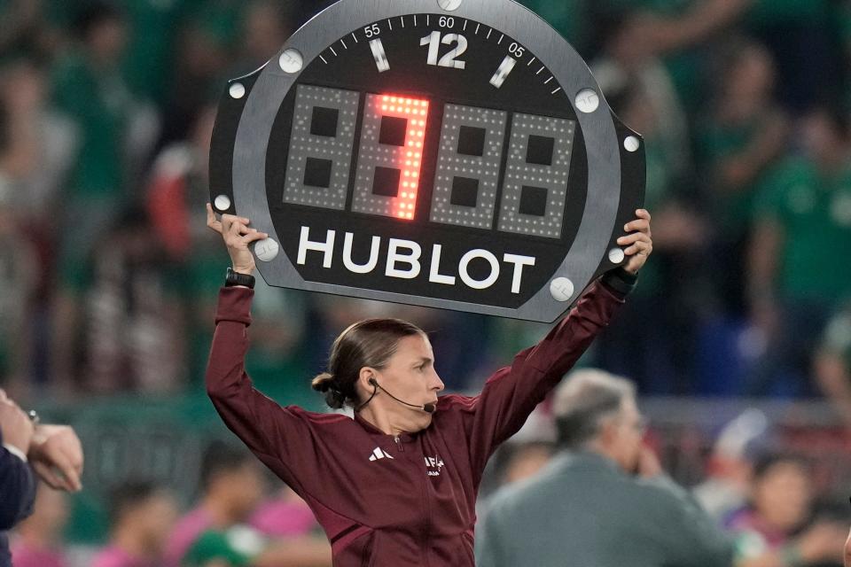 Referee assistant Stephanie Frappart of France shows 7 minutes overtime during the World Cup group C soccer match between Mexico and Poland, at the Stadium 974 in Doha, Qatar, Tuesday, Nov. 22, 2022.