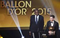 FC Barcelona's Lionel Messi of Argentina receives the FIFA Ballon d'Or 2015 for the world player of the year, as FIFA acting President Issa Hayatou (L) watches, during an awards ceremony in Zurich, Switzerland, January 11, 2016 REUTERS/Ruben Sprich