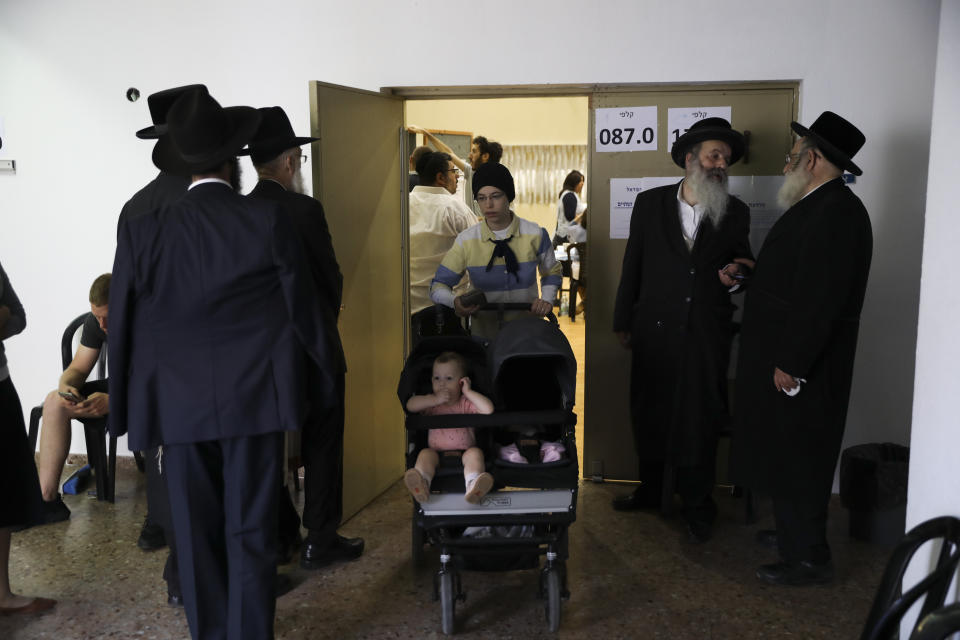 Ultra orthodox Jews line up to vote in Bnei Brak, Israel, Tuesday, Sept. 17, 2019. Israelis began voting Tuesday in an unprecedented repeat election that will decide whether longtime Prime Minister Benjamin Netanyahu stays in power despite a looming indictment on corruption charges. (AP Photo/Oded Balilty)