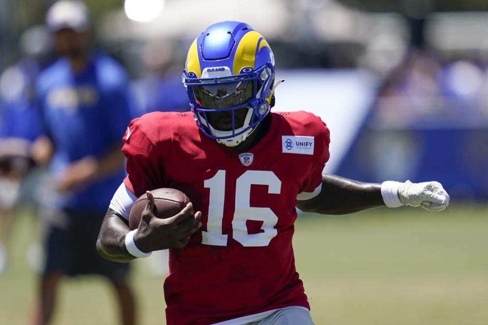 Rams quarterback Bryce Perkins scrambles during a drill at training camp.