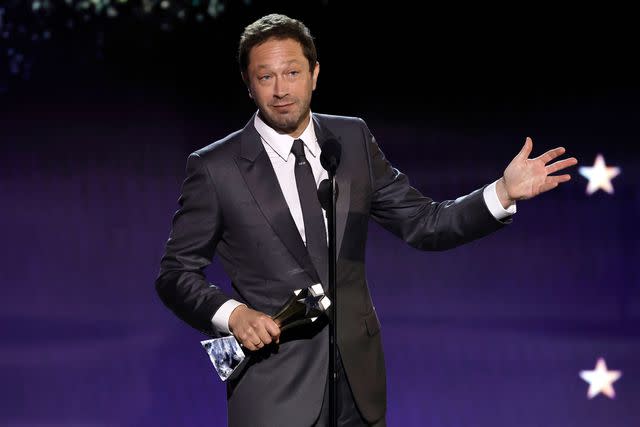 <p>Kevin Winter/Getty</p> Ebon Moss-Bachrach accepts the best supporting actor in a comedy series at the 29th Annual Critics Choice Awards on Jan. 14, 2024.