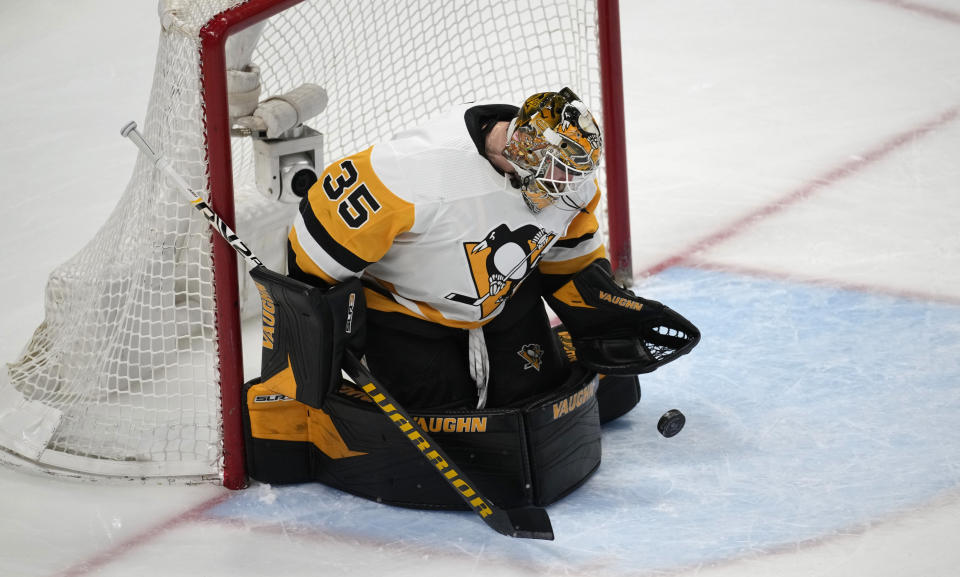 Pittsburgh Penguins goaltender Tristan Jarry stops a shot in the third period of an NHL hockey game against the Colorado Avalanche Wednesday, March 22, 2023, in Denver. (AP Photo/David Zalubowski)