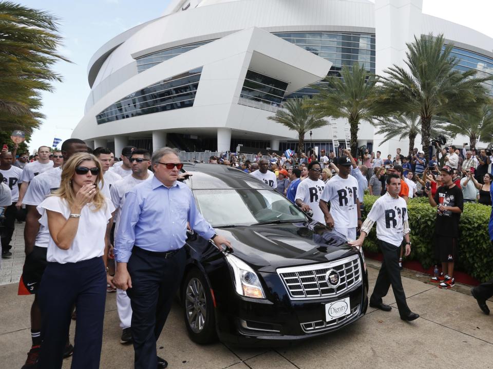 <p>Miami Marlins owner and CEO Jeffrey Loria, second left, and Marlins president David Samson, right, lead players and staff as they escort a hearse carrying the body of pitcher Jose Fernandez as it leaves Marlins Park stadium, Wednesday, Sept. 28, 2016, in Miami. Fernandez was killed in a weekend boat crash along with two friends. (AP Photo/Wilfredo Lee) </p>