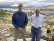 In this Tuesday, Oct. 5, 2021, photo, The Dalles city Public Works Department Director Dave Anderson, left, and Mayor Richard Mays pose for photos in The Dalles, Oregon. Mays helped negotiate a proposal by Google to build new data centers in the town. The data centers require a lot of water to cool their servers, and would use groundwater and surface water, but not any water from the Columbia River. (AP Photo/Andrew Selsky)