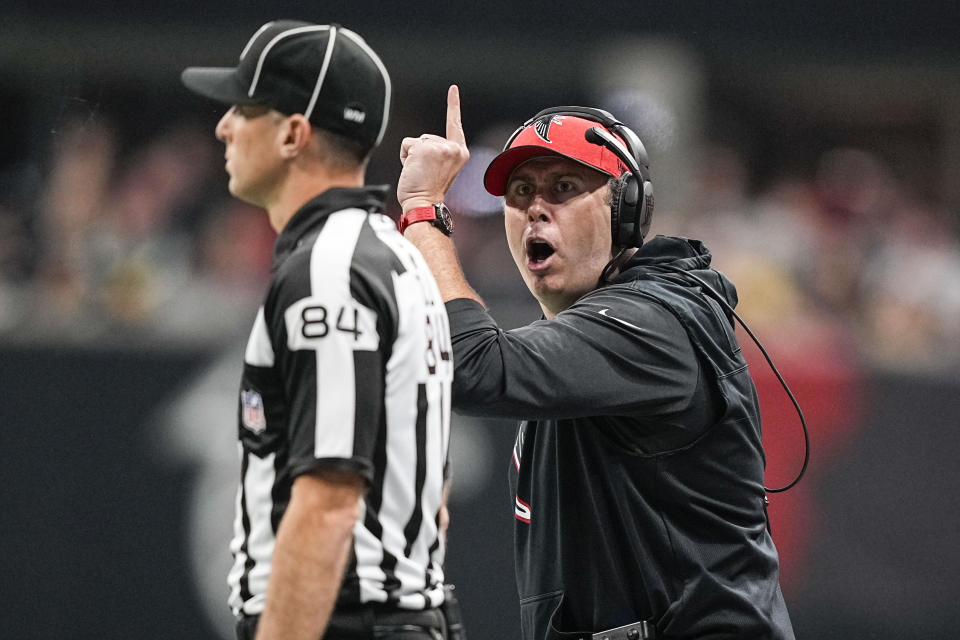 Atlanta Falcons head coach Arthur Smith speaks with line judge Mark Steinkerchner (84) during the second half of an NFL football game between the Atlanta Falcons and the Pittsburgh Steelers, Sunday, Dec. 4, 2022, in Atlanta. (AP Photo/Brynn Anderson)