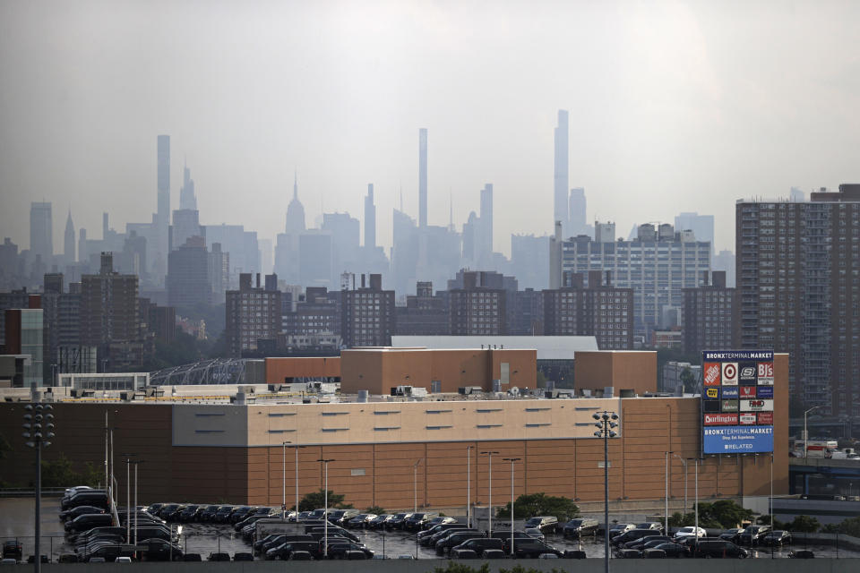 Manhattan is seen from Yankee Stadium through a haze of smoke before a baseball game between the Philadelphia Phillies and the New York Yankees, Wednesday, July 21, 2021, in New York. Wildfires in the American West, including one burning in Oregon that's currently the largest in the U.S., are creating hazy skies as far away as New York as the massive infernos spew smoke and ash into the air in columns up to six miles high. (AP Photo/Adam Hunger)