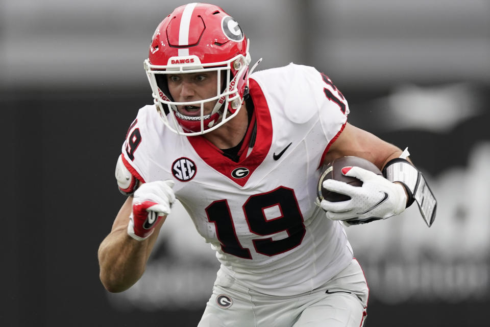 FILE - Georgia tight end Brock Bowers (19) runs the ball after a catch against Vanderbilt in the first half of an NCAA college football game Saturday, Oct. 14, 2023, in Nashville, Tenn. Bowers has been selected to The Associated Press midseason All-America team, Wednesday, Oct. 18, 2023.(AP Photo/George Walker IV, File)