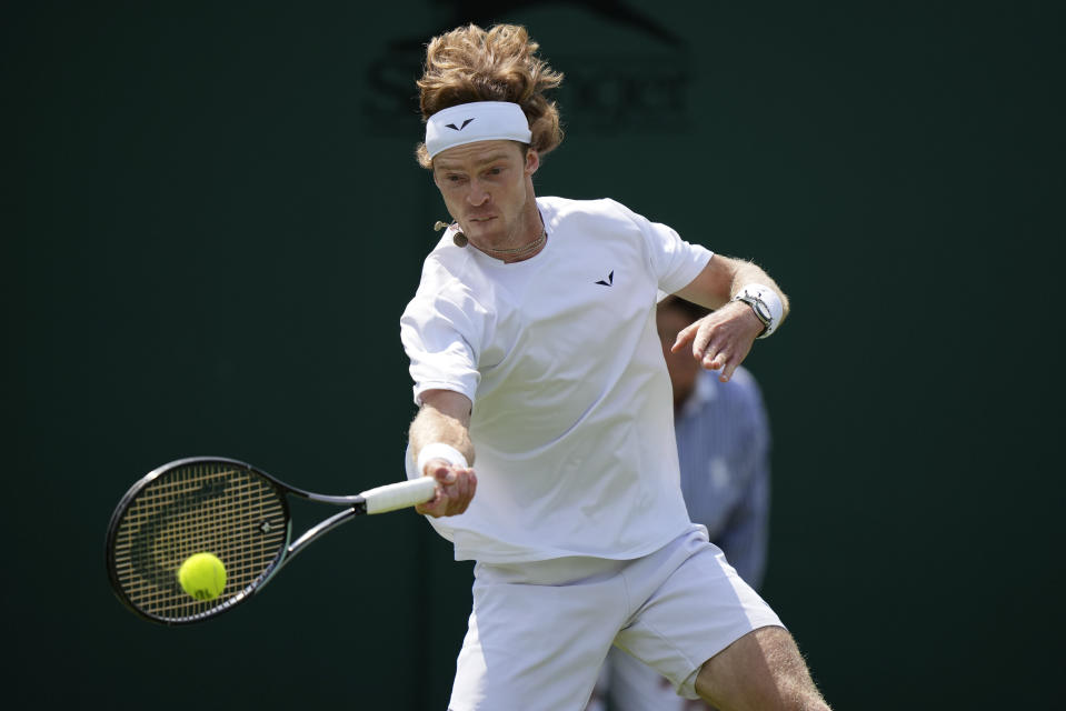 Russia's Andrey Rublev returns to Australia's Max Purcell during their first round men's singles match on day one of the Wimbledon tennis championships in London, Monday, July 3, 2023. (AP Photo/Alberto Pezzali)