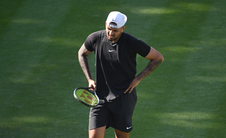 Nick Kyrgios reacts during a tennis match.