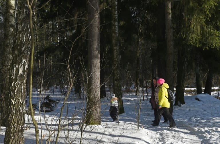 People walk through the Chelyuskinsky Wood outside Moscow