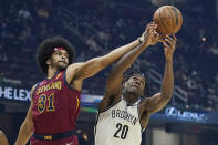 Cleveland Cavaliers' Jarrett Allen (31) and Brooklyn Nets' Day'Ron Sharpe (20) battle for a rebound in the first half of an NBA basketball game, Monday, Jan. 17, 2022, in Cleveland. (AP Photo/Tony Dejak)