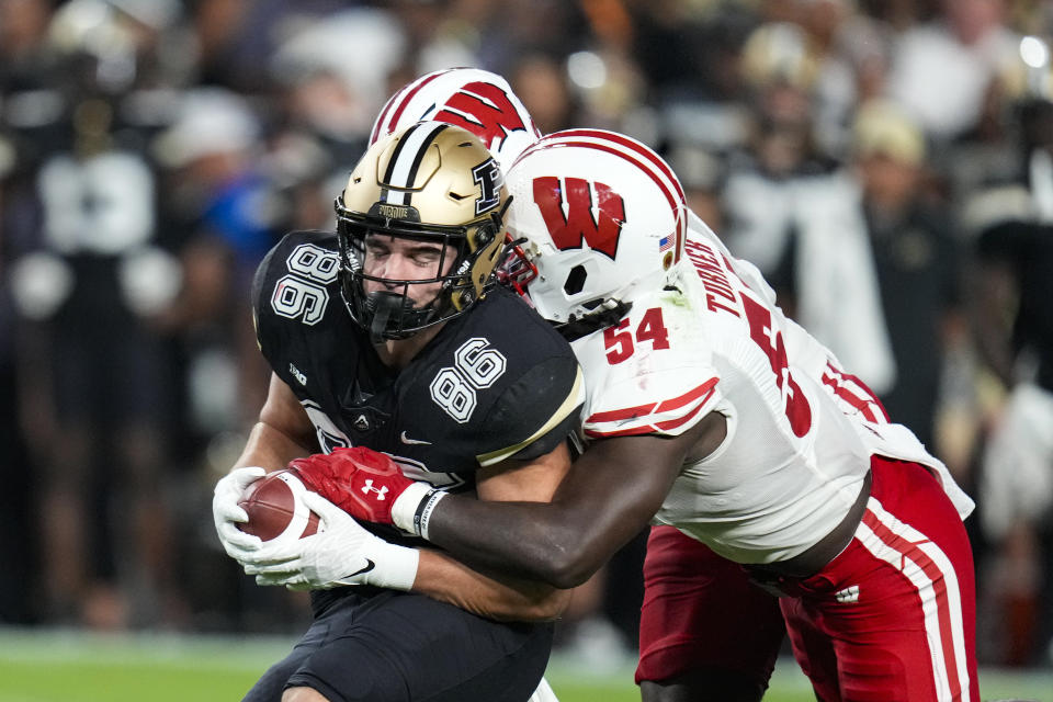 Wisconsin linebacker Jordan Turner (54) tackles Purdue tight end Max Klare (86) during the first half of an NCAA college football game in West Lafayette, Ind., Friday, Sept. 22, 2023. (AP Photo/Michael Conroy)
