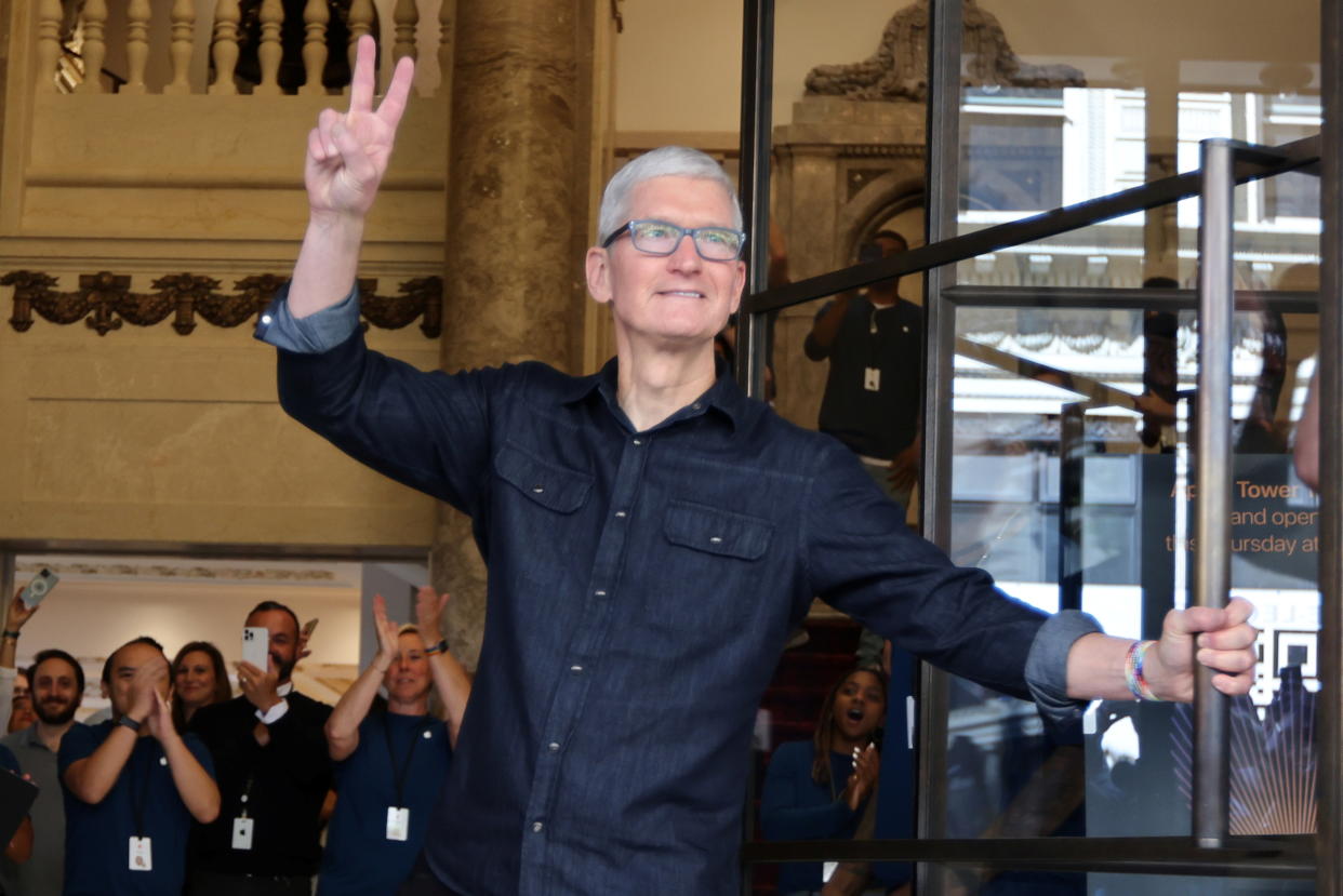 Apple CEO Tim Cook greets customers at the new Apple Store on Broadway in downtown Los Angeles, California, U.S., June 24, 2021. REUTERS/Lucy Nicholson
