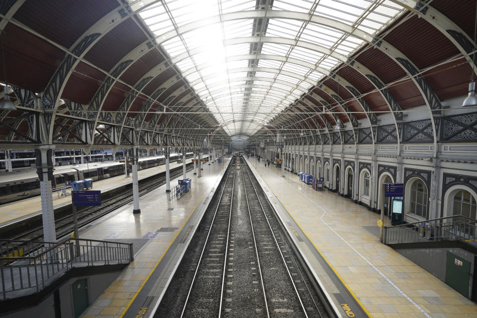 Empty platforms are seen at Paddington train station during a 24-hour strike by four transportation trade unions, in London, Saturday, Oct. 1, 2022. Trains in Britain all but ground to a halt Saturday as coordinated strikes by rail workers added to a week of turmoil caused by soaring energy prices and unfunded tax cuts that roiled financial markets. (James Manning/PA via AP)