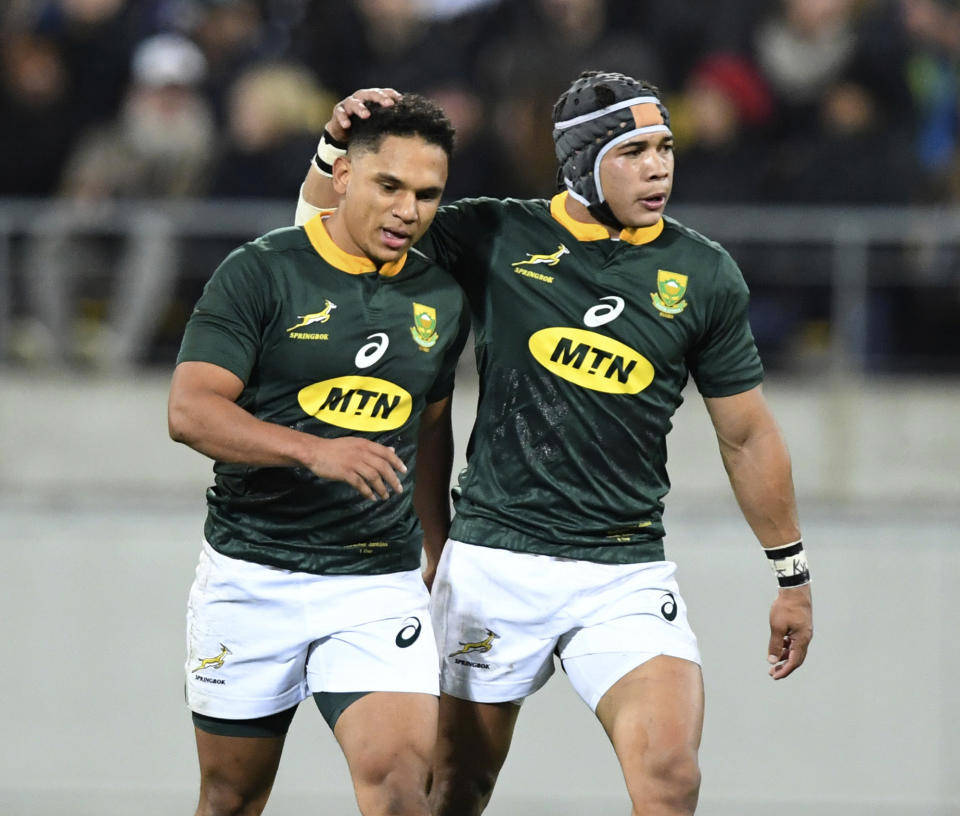 South Africa's Herschel Jantjies, left, is congratulated by teammate Cheslin Kolbe after scoring against New Zealand during a Rugby Championship match between the All Blacks and South Africa in Wellington, New Zealand, Saturday, July 27, 2019. (AP Photo/Ross Setford)